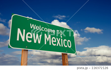 Welcome To New Mexico Green Road Sign Over Blue Sky with Some Clouds. 116372126
