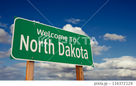 Welcome To North Dakota Green Road Sign Over Blue Sky with Some Clouds. Welcome To North Dakota Green Road Sign Over Blue Sky with Some Clouds. 116372129