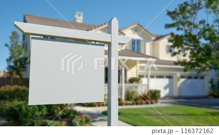 Blank Real Estate Sign in Front of Beautiful House. Blank Real Estate Sign in Front of Beautiful House. 116372162