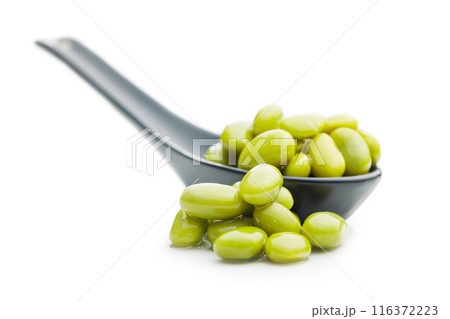 Edamame soy beans in ceramic spoon isolated on white background. Edamame soy beans in ceramic spoon isolated on white background. 116372223