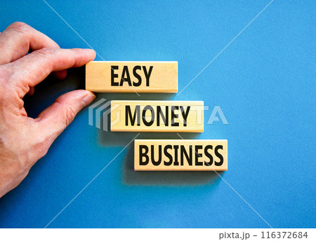 Easy money business symbol. Concept words Easy money business on beautiful wooden blocks. Beautiful blue table blue background. Businessman hand. Easy money business concept. Copy space. Easy money business symbol. Concept words Easy money business on beautiful wooden blocks. Beautiful blue table blue background. Businessman hand. Easy money business concept. Copy space. 116372684