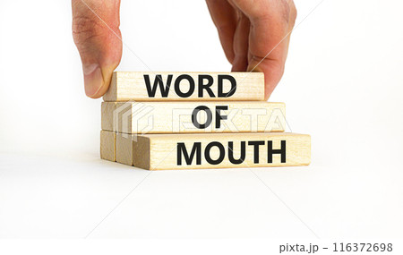Word of mouth symbol. Concept words Word of mouth on wooden blocks on a beautiful white table white background. Businessman hand. Business, finacial and word of mouth concept. Copy space. 116372698