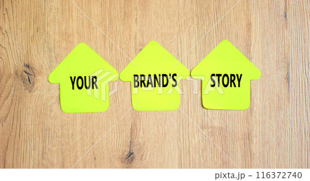 Branding and your brand story symbol. Concept words Your brands story on beautiful yellow paper houses. Beautiful wooden table background. Business branding and your brand story concept. Copy space. Branding and your brand story symbol. Concept words Your brands story on beautiful yellow paper houses. Beautiful wooden table background. Business branding and your brand story concept. Copy space. 116372740