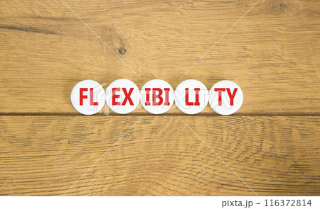 Flexibility symbol. Concept word Flexibility on beautiful white pill. Beautiful wooden background. Business flexibility concept. Copy space. 116372814