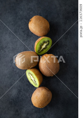 Fresh and sweet kiwi fruits on a dark background. The concept of healthy and dietary food. Top view 116373609