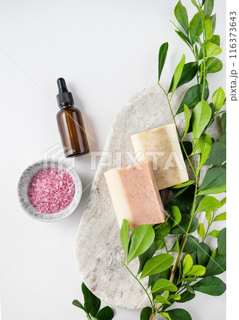 Concept flat lay of facial and body care cosmetics with pink sea salt, soap and cream  116373643