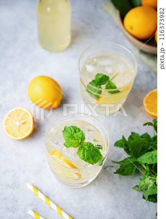 Lemonade soda drink with fresh lemons. Refreshing cocktail with lemon, mint and ice 116373982