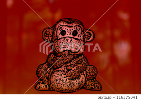 Monkey figurine on a red background. A lonely sitting monkey holds a finger in its mouth. Monkey figurine on a red background. A lonely sitting monkey holds a finger in its mouth. 116375041