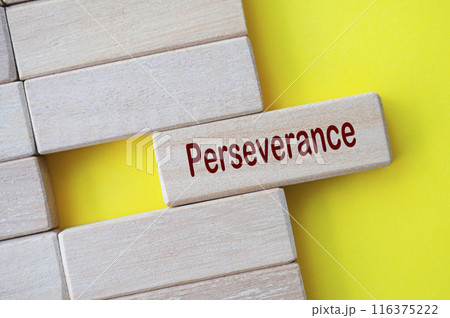 Perseverance text written on wooden blocks with yellow cover background 116375222
