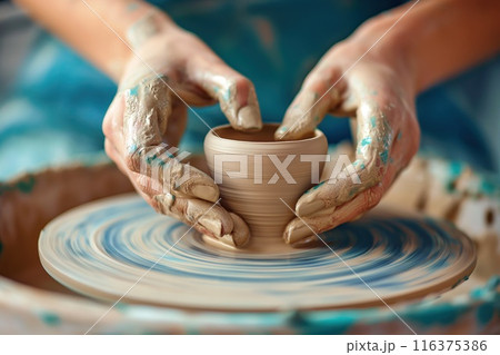 Hands of girl creating bowl on potter's wheel. 116375386