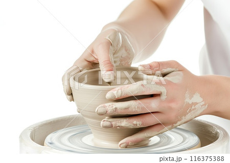 Hands of woman creating bowl on potter's wheel isolated on white background 116375388