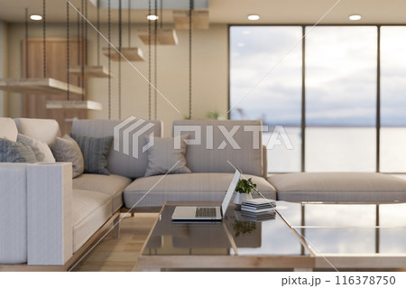 A laptop computer on a modern coffee table in a contemporary luxurious living room. 116378750