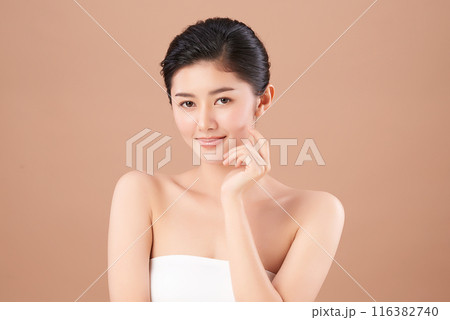 Beautiful young asian woman with clean fresh skin on beige background, Face care, Facial treatment, Cosmetology, beauty and spa, Asian women portrait. 116382740