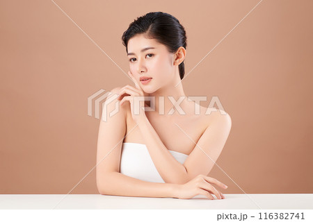 Beautiful young asian woman with clean fresh skin on beige background, Face care, Facial treatment, Cosmetology, beauty and spa, Asian women portrait. Beautiful young asian woman with clean fresh skin on beige background, Face care, Facial treatment, Cosmetology, beauty and spa, Asian women portrait. 116382741