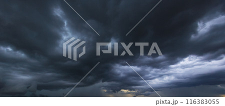 The dark sky with heavy clouds converging and a violent storm before the rain.Bad or moody weather sky and environment. carbon dioxide emissions, greenhouse effect, global warming, climate change 116383055