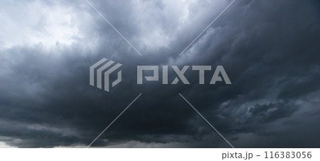 Bad or moody weather sky and environment. The dark sky with heavy clouds converging and a violent storm before the rain. carbon dioxide emissions, greenhouse effect, global warming, climate change 116383056