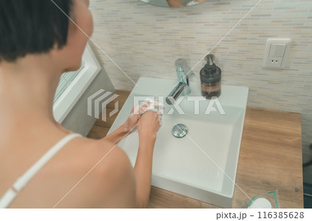 自宅の洗面台で手を洗う50代女性の手元 116385628