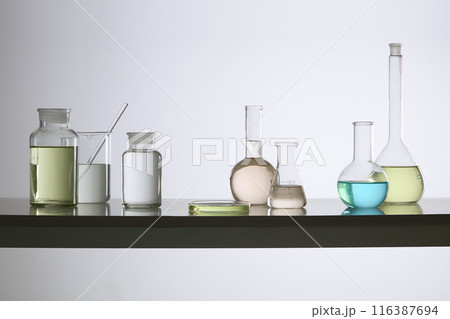 Variety experiment instruments neatly arranged as a horizontal row on the laboratory countertop, over white background. Photo of front view, empty space for designing Variety experiment instruments neatly arranged as a horizontal row on the laboratory countertop, over white background. Photo of front view, empty space for designing 116387694