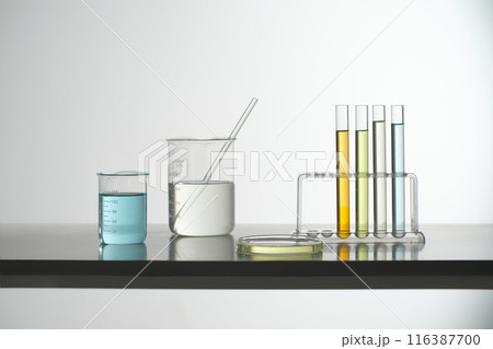 Some laboratory instrument filled by colorful liquid, against on the white background. Photo for advertising pic, was taken from front with blank space for promotional Some laboratory instrument filled by colorful liquid, against on the white background. Photo for advertising pic, was taken from front with blank space for promotional 116387700