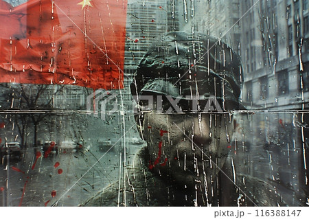 Man wearing a cap looking through a window with a chinese flag reflecting in the glass 116388147