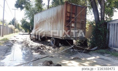 Semi trailer truck stuck on flooded road after natural disaster 116388471