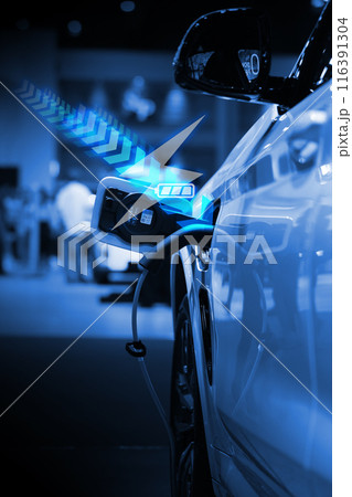 Power cable pump plug in charging power to electric vehicle EV car. 116391304