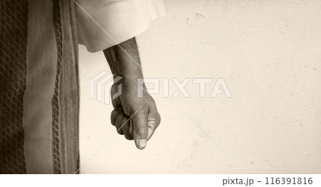 Man clenched his fist against a white wall Man clenched his fist against a white wall 116391816