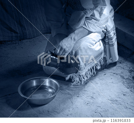 Male slave serve in the house pouring water 116391833