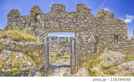 View through the entrance gate of the castle to the small Italian town of Tolfa 116394098