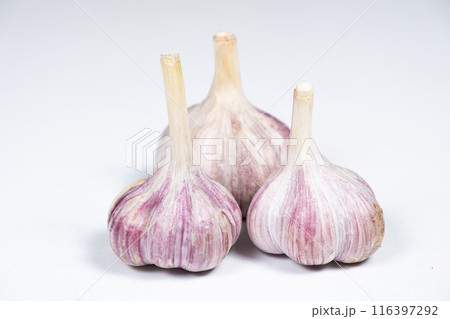 Three unpeeled fresh bulbs of garlic on a white isolate background Three unpeeled fresh bulbs of garlic on a white isolate background 116397292