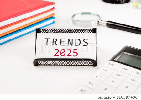 2025 business marketing trends and planning change concept. TRENDS 2025 on a business card in a stand on a white background 2025 business marketing trends and planning change concept. TRENDS 2025 on a business card in a stand on a white background 116397406
