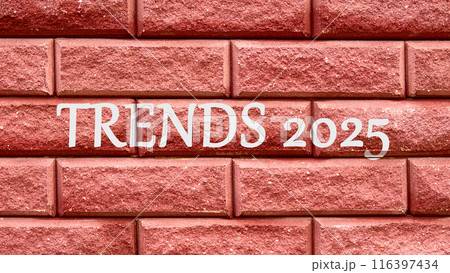 Plan finances investments and savings. TRENDS 2025 on a red decorative brick 116397434