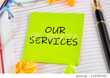 Business concept. OUR SERVICES on a light green sticker lying on the notebook Business concept. OUR SERVICES on a light green sticker lying on the notebook 116397447