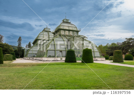 Vienna, Austria, August 20, 2022. In the gardens of Schonbrunn Palace, the historic greenhouse stands out for its characteristic design. Travel destinations. Copy space Vienna, Austria, August 20, 2022. In the gardens of Schonbrunn Palace, the historic greenhouse stands out for its characteristic design. Travel destinations. Copy space 116397556