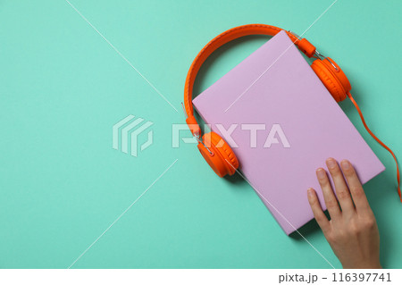 Books with modern headphones, audio book concept, on green background. 116397741