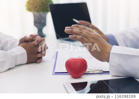 Doctor explaining heart to patient about details and risks operation. Healthcare and medical concept. Physician explaining health exam to patient. 116398109