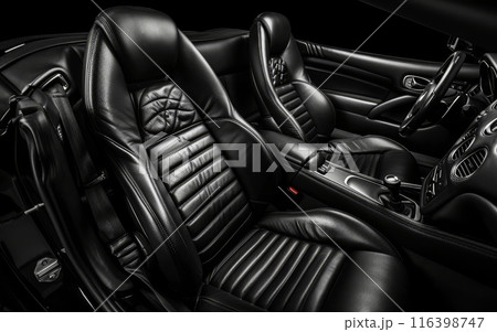 The photograph highlights the luxury of black leather car seats with a dynamic contrast against dark details. The cabin evokes a feeling of high-end sophistication with every stitch. The photograph highlights the luxury of black leather car seats with a dynamic contrast against dark details. The cabin evokes a feeling of high-end sophistication with every stitch. 116398747