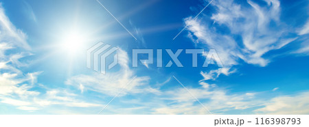 Blue sky with white clouds and sun. Wide photo. 116398793