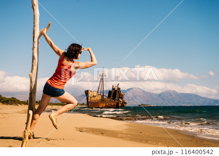 Tourist woman on beach enjoying vacation 116400542