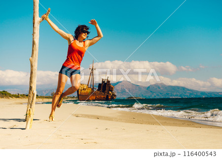 Tourist woman on beach enjoying vacation 116400543