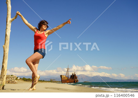 Tourist woman on beach enjoying vacation 116400546
