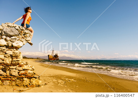 Tourist woman on beach enjoying vacation 116400547