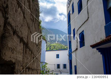 View from the narrow alley to the mosque on the hill in the distance. Morocco. View from the narrow alley to the mosque on the hill in the distance. Morocco. 116400951