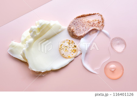 Different cosmetic textures on a delicate peach background.  116401126