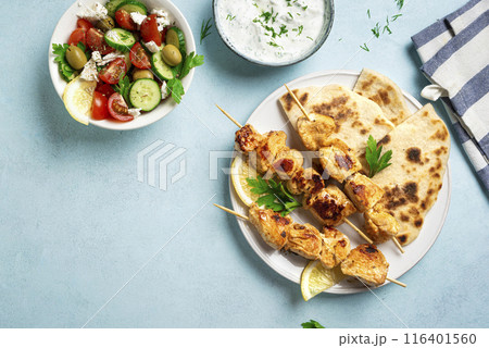 Chicken souvlaki kebabs and greek salad 116401560