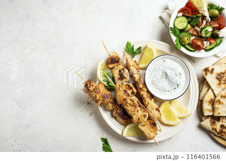 Chicken skewers ans greek vegetable salad Chicken skewers ans greek vegetable salad 116401566