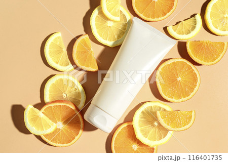 White tube of beauty product with citrus fruit slices White tube of beauty product with citrus fruit slices 116401735