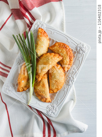 Fried chebureks, close-up, on a light background, no people, Fried chebureks, close-up, on a light background, no people, 116402318