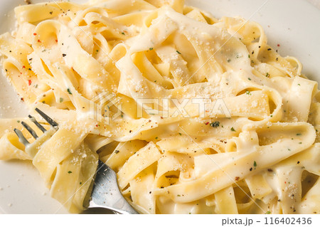 Fettuccine, tagliatelle, in creamy garlic sauce, Italian traditional cuisine, pasta carbonaro, Fettuccine, tagliatelle, in creamy garlic sauce, Italian traditional cuisine, pasta carbonaro, 116402436