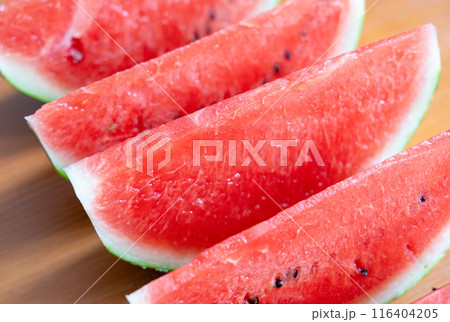 Watermelon slices closeup. Water melon wedges pile, Citrullus lanatus pieces, red wassermelone cuts group 116404205
